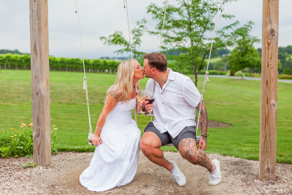 Chelsea and Julian enjoying the rustic swings during their engagement session at Folino Estate Winery.