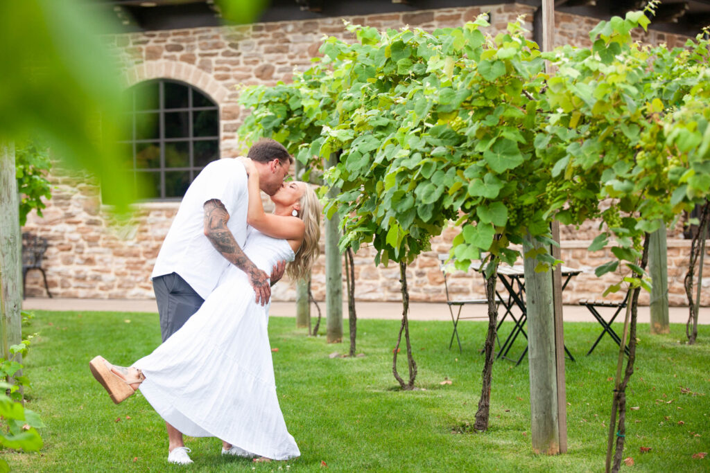 Chelsea and Julian walking through the vineyard during their engagement session at Folino Estate Winery.
