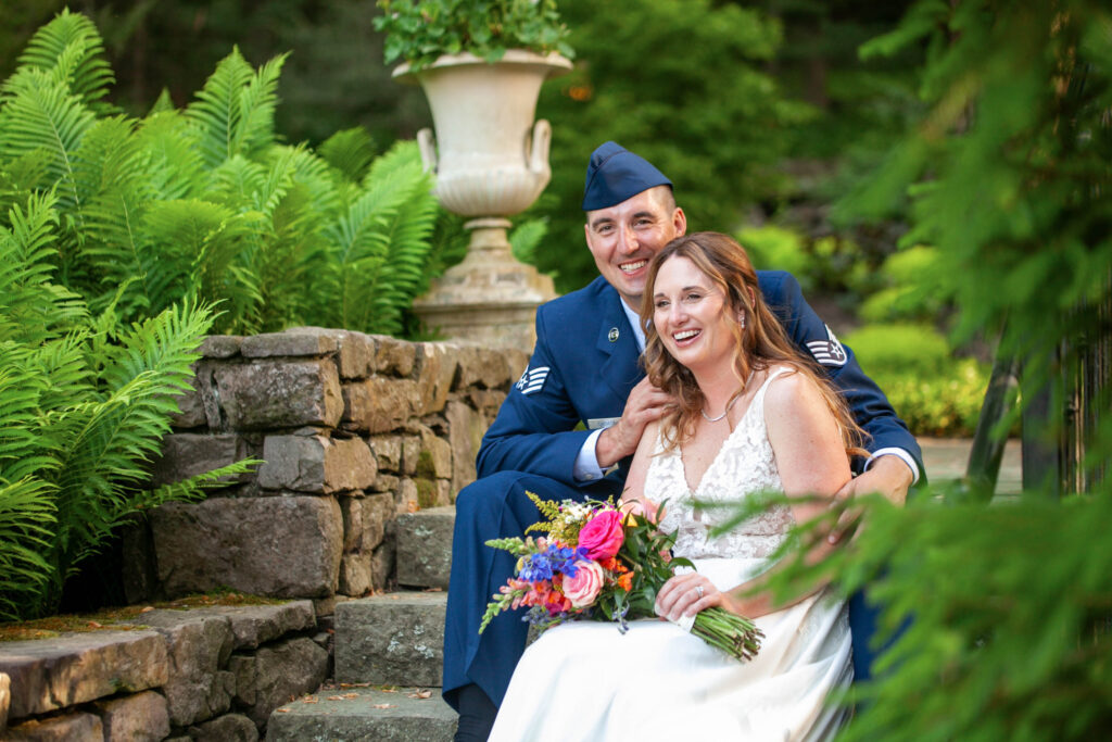 A candid, connected moment as the bride and groom sit together at The Black Bass Hotel’s Terrace in the Woods in Lumberville, Pennsylvania.