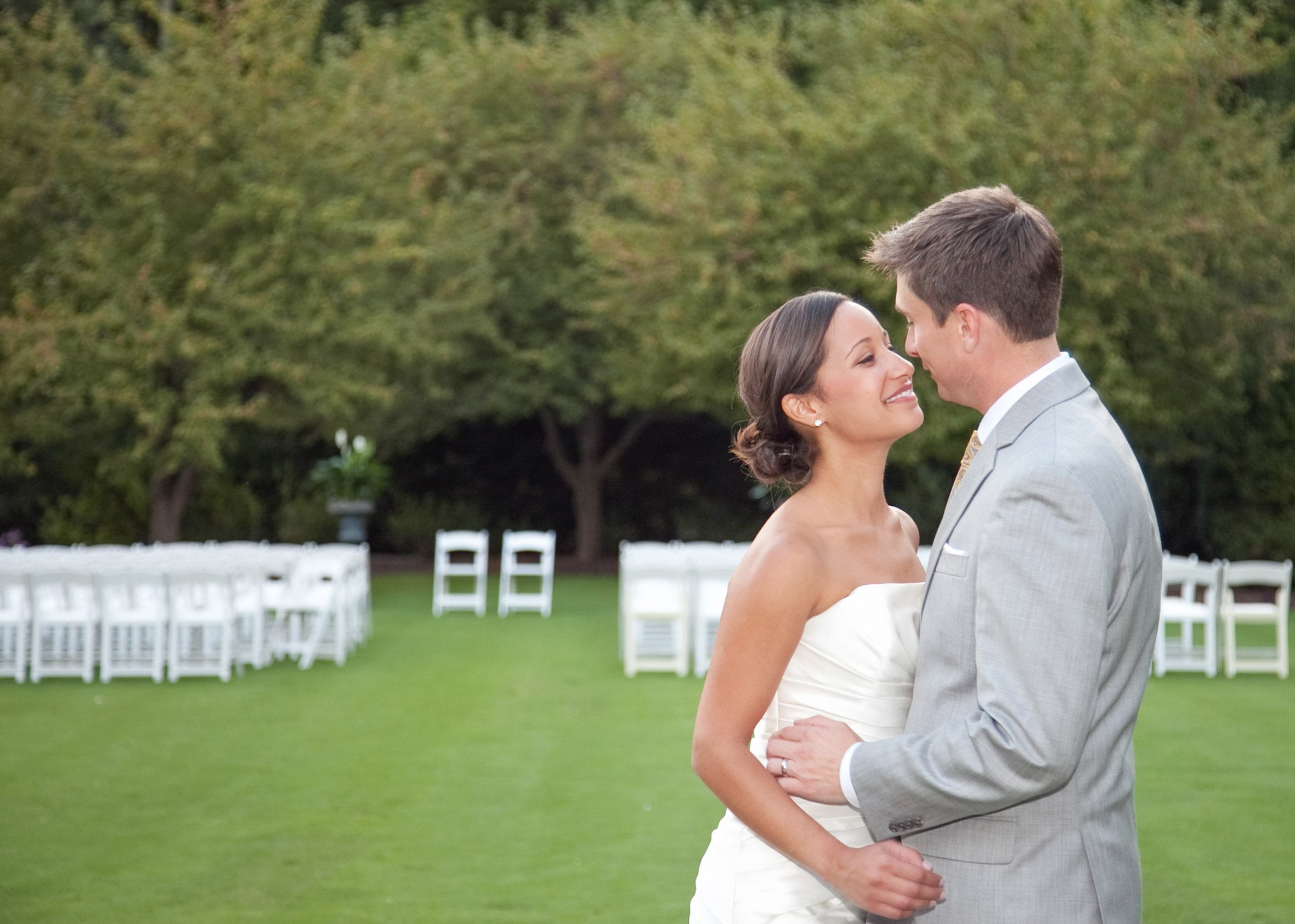 Bride and groom embracing on the ceremony lawn at Brantwyn Estate in Wilmington, Delaware.