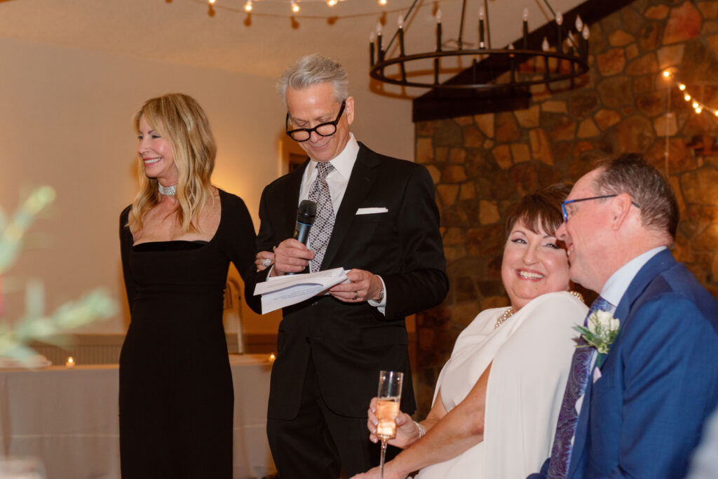 A joyful reception toast inside Holly Hedge Estate celebrates the couple surrounded by friends and family.