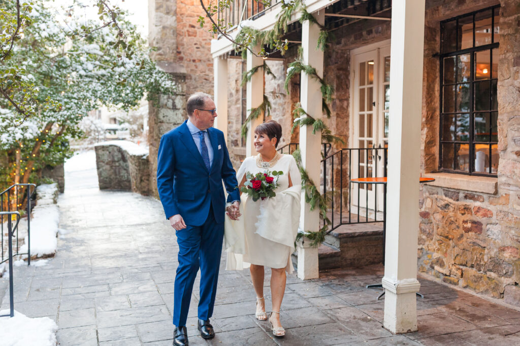 A cozy winter wedding moment at HollyHedge Estate, with snow on the ground, soft light, and a quiet, meaningful walk together before the celebration continued indoors.